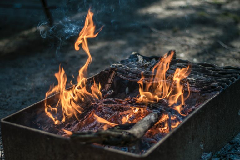 a barbeque on fire on a balcony in a block of flats