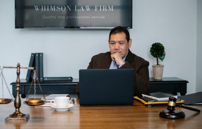 A lawyer sitting in his office on his laptop studying the right of first refusal